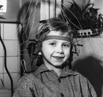 Child wearing old wired EEG headset